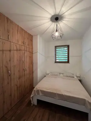 a bedroom with a bed and a window at Apartman Palazzo in Bosanska Krupa