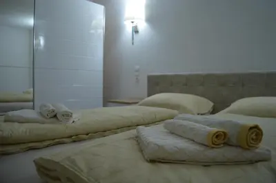 two beds in a room with towels on them at Apartman Amela Deluxe in Kulen Vakuf
