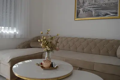a living room with a couch and a table at Apartman Amela Deluxe in Kulen Vakuf