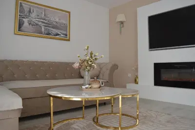 a living room with a couch and a table at Apartman Amela Deluxe in Kulen Vakuf