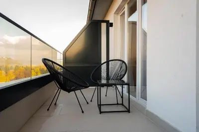 two chairs and a table on a balcony at Apartman 101 in Visoko