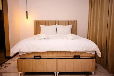 a bed with two towels on top of it at Apartman 101 in Visoko