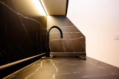 a kitchen sink with a faucet in a room at Apartman 101 in Visoko