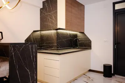 a kitchen with a black and white counter top at Apartman 101 in Visoko