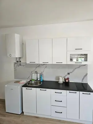 a white kitchen with a sink and a white refrigerator at Jelena in Jajce