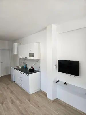 a kitchen with white cabinets and a flat screen tv at Jelena in Jajce