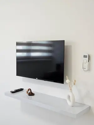 a flat screen tv sitting on a white wall at Jelena in Jajce