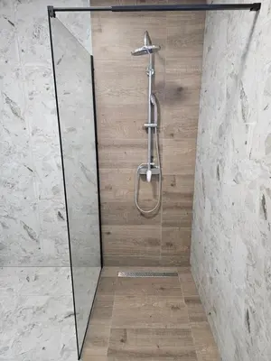 a shower with a glass door and a shower head at Jelena in Jajce