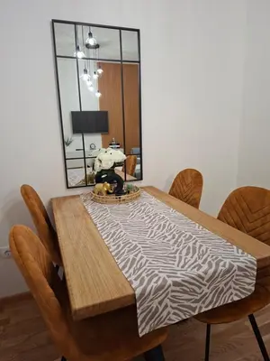 a dining room table with a zebra print table cloth at Apartman Nina Residence Banja Luka in Banja Luka
