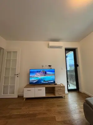 a living room with a flat screen tv on a cabinet at Divna Besplatan parking in Banja Luka