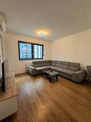 a living room with a couch and a table at Divna Besplatan parking in Banja Luka