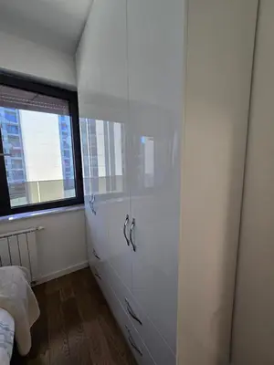 a white cabinet in a room with a window at Divna Besplatan parking in Banja Luka