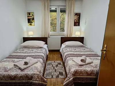 two beds in a room with a window at Haus Viktoria near Banja Luka in Banja Luka
