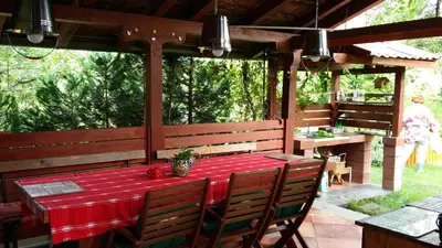 a table with a red table cloth on a patio at Haus Viktoria near Banja Luka in Banja Luka