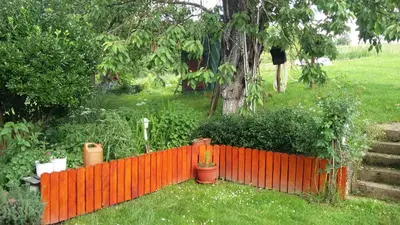 an orange fence in a yard with plants and a tree at Haus Viktoria near Banja Luka in Banja Luka