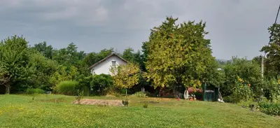 a house in the middle of a grassy field at Haus Viktoria near Banja Luka in Banja Luka