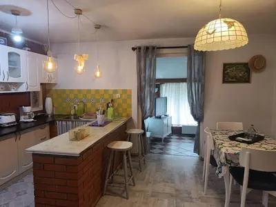 a kitchen with a counter and a table with chairs at Haus Viktoria near Banja Luka in Banja Luka