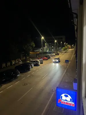 a street at night with cars parked in a parking lot at Stan na dan Ana in Prozor