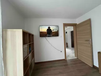 a living room with a tv on a wall at Vila Fina in Laktaši