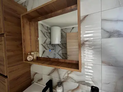 a bathroom with a sink and a mirror at Vila Fina in Laktaši