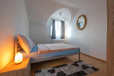 a small room with a bed and a mirror at Apartmani Božur in Bosanska Gradiška