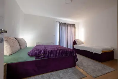 a bedroom with two beds and a window at Apartmani Božur in Bosanska Gradiška