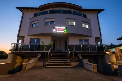a building with a sign on the side of it at Apartmani Božur in Bosanska Gradiška