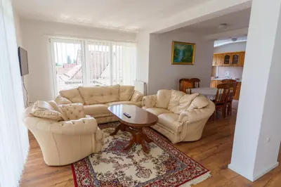 a living room with two couches and a table at Motel Aqua Kozarac in Kozarac