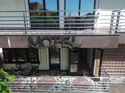 a balcony with a metal sign on a building at Motel Aqua Kozarac in Kozarac