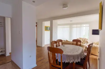 a dining room and kitchen with a table and chairs at Motel Aqua Kozarac in Kozarac