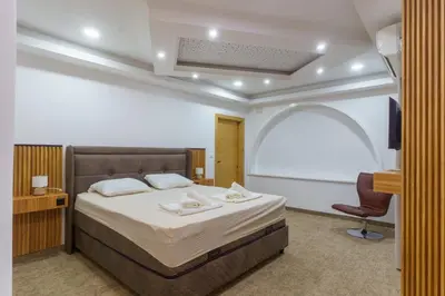 a bedroom with a bed and a chair in it at Motel Aqua Kozarac in Kozarac