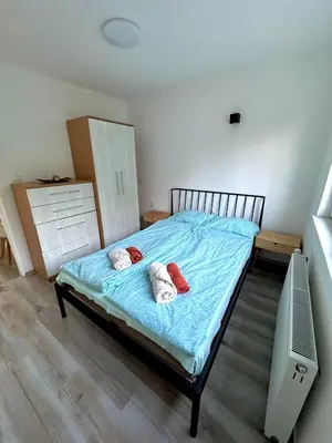 a bedroom with a bed with towels on it at Apartmani Fazinasa