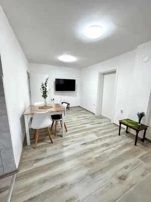 a living room with a table and a television at Apartmani Fazinasa