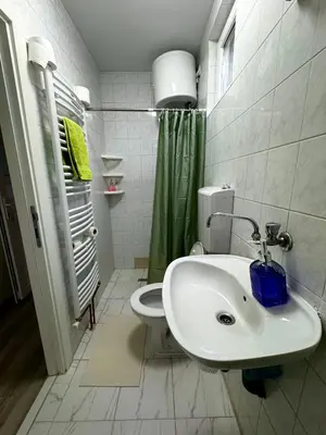 a white bathroom with a toilet and a sink at Apartmani Fazinasa