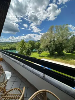 a balcony with chairs and a view of a river at Apartman Hanna