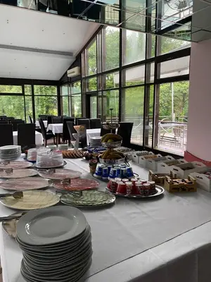 a long table with plates of food on it at Apartman Hanna