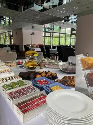 a table topped with plates of food on top at Apartman Hanna