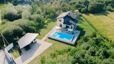 an aerial view of a house with a swimming pool at Velvet House Lohovo in Bihać