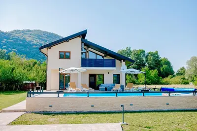 a villa with a swimming pool and a house at Velvet House Lohovo in Bihać