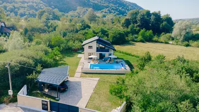 an aerial view of a house with a swimming pool at Velvet House Lohovo in Bihać