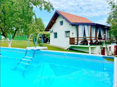 a swimming pool in front of a house at Vikendica Sarah in Tuzla