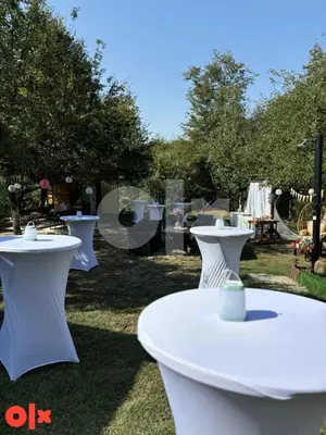 a group of white tables sitting in the grass at Vikendica Sarah in Tuzla