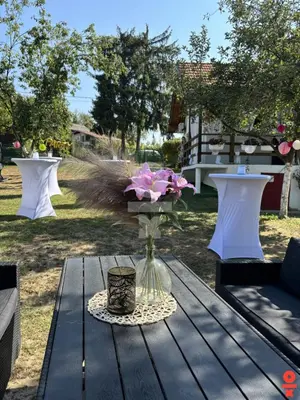 a vase of flowers sitting on a wooden table at Vikendica Sarah in Tuzla
