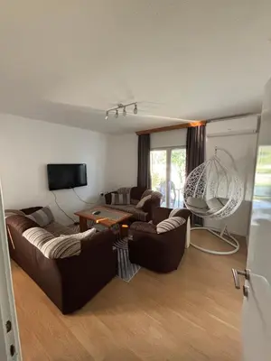a living room with two couches and a tv at Horizont Bihać in Bihać