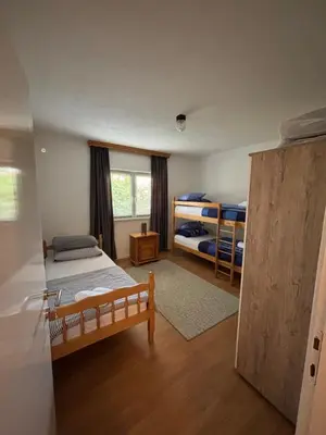 a bedroom with two bunk beds and a window at Horizont Bihać in Bihać