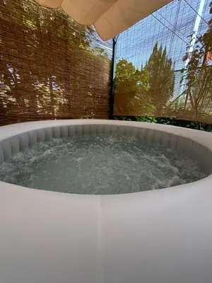 a hot tub with water in it in a backyard at Horizont Bihać in Bihać