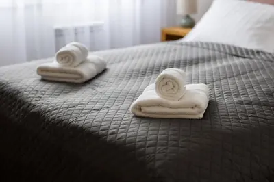 two towels sitting on top of a bed at Polza in Banja Luka