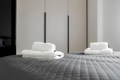 two towels sitting on top of a bed at Polza in Banja Luka
