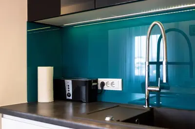 a kitchen with blue walls and a sink with a toaster at Polza in Banja Luka