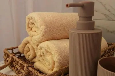 a pile of towels in a basket next to a faucet at Ćeif HOUSE in Bihać